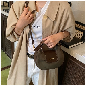 Detail of the vintage brown suede patchwork half-moon bag with adjustable leather strap