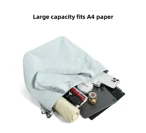Detailed top view of a large nylon tote bag showing spacious interior for A4 paper and gadgets