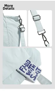 Detail view of reinforced stitching and dark gray metal buckles on light blue tote bag