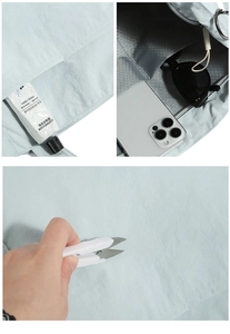 Detail of light blue nylon crossbody bag showing interior compartments and scratch resistance