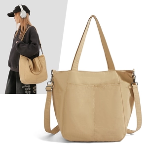 Detailed view of khaki large capacity nylon tote bag with wide adjustable shoulder strap