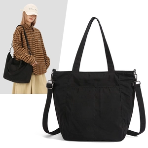 Detail of black waterproof nylon tote bag showing fabric texture and adjustable strap