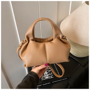 Detail view of khaki cloud bag with premium lychee grain texture and pleated design