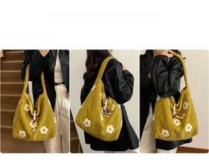 Detail view of mustard yellow plush tote bag with white floral pattern and toggle closure