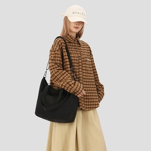 Large black crossbody tote bag with adjustable straps in Japanese minimalist style