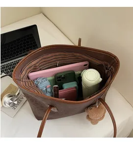 Detail view of brown leather tote bag interior showing spacious capacity for daily essentials