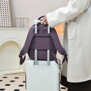 Purple nylon backpack with back trolley sleeve and anti-theft zipper for travel