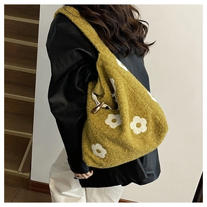Detail of mustard yellow plush tote bag with flower pattern and wooden horn buckle