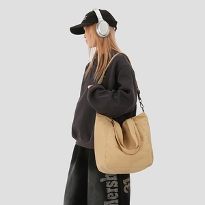 Khaki large capacity crossbody tote bag styled with casual streetwear for daily commute
