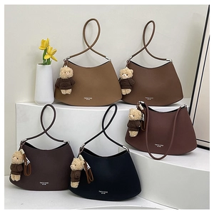 Detailed arrangement of five colorful underarm bags with cute brown bear charms