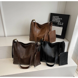 Detailed view of high-quality PU leather texture and adjustable metal buckles on tote bags