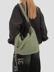 Olive green canvas hobo shoulder bag with adjustable strap and dual webbing handles