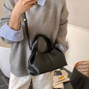 Model wearing a black lychee texture cloud bag as a crossbody purse for commuting