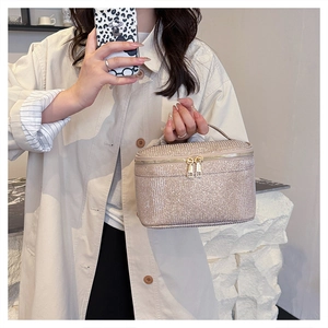 Dettaglio della trousse glitter color oro champagne con doppia cerniera e manico