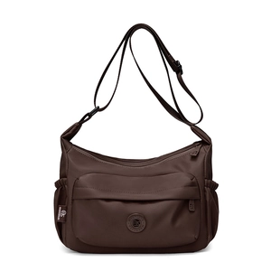 Detailed view of dark brown nylon crossbody bag with front zipper and side elastic pockets