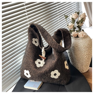 Close-up of plush floral tote bag featuring a wooden toggle closure and soft texture