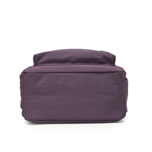 Flat bottom structure and seam detail of the purple nylon travel backpack on white background