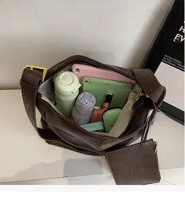 Interior view of large brown faux leather crossbody bag showing spacious storage capacity