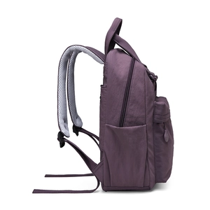 Side view of dark purple nylon backpack with breathable mesh straps and bottle pocket
