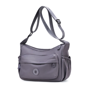Detail of grey waterproof nylon crescent bag featuring side pockets and adjustable strap
