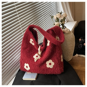 Close-up of plush flower embroidery tote bag with woven horn buckle detail