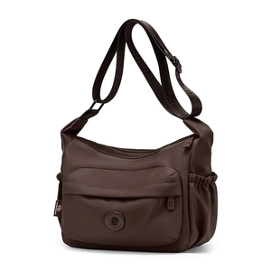 Close-up of waterproof nylon crossbody bag with multi-pocket design and adjustable strap