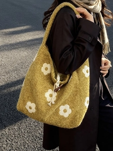 Mustard yellow plush tote bag with white floral pattern and drawstring closure