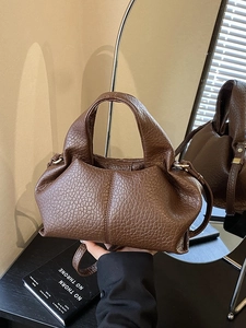 Elegant dark brown cloud tote bag with pebble leather texture and crossbody strap
