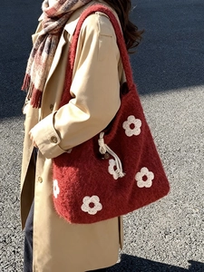 Red plush flower tote bag with white floral applique and drawstring shoulder strap