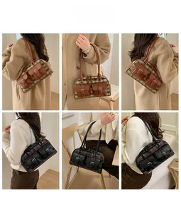 Detail view of vintage plaid tote bag in green and grey patterns on model shoulder
