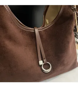 Detailed view of dark brown suede tote with premium silver metal ring hardware accessory