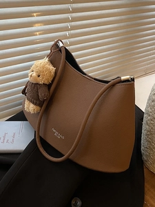 Brown leather crescent hobo underarm bag with a cute bear pendant decoration