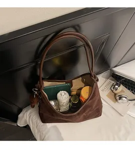 Spacious interior of brown suede tote bag showing tablet, umbrella and daily essentials