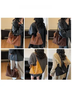 Detail view of large suede tote bags in various colors with plush bear charm accessory