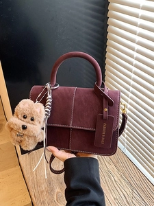 Burgundy matte square handbag with contrast stitching and brown teddy bear charm