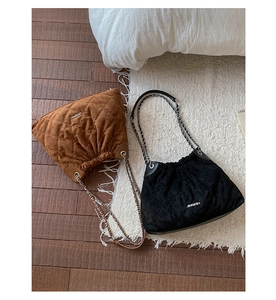 Top view of quilted suede bucket bags with chain straps in brown and black colors