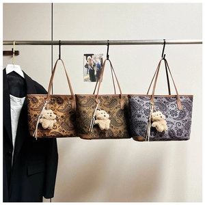 Detailed comparison of vintage paisley tote bags in brown and purple with bear charms
