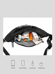 Macro detail of spacious black checkered fanny pack interior with various travel essentials