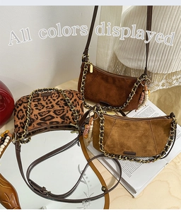 Detail view of leopard print and suede Boston crossbody bags with tassels and chain straps