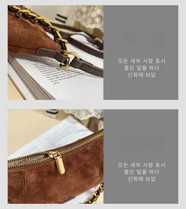 Detail of vintage gold chain strap and metal zipper on brown suede shoulder bag