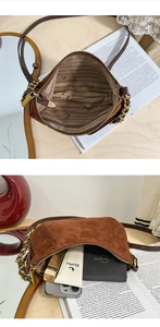 Detail view of brown suede crossbody bag with gold chain strap and interior zip pocket