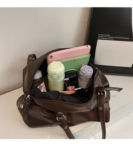 Spacious interior of a vintage dark brown tote bag showing capacity for a tablet and water bottle
