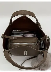 Interior view of brown pebble leather bucket bag showing large capacity and inner pouch