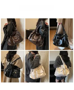Detail view of vintage large tote bag in black, brown and beige soft leather on model