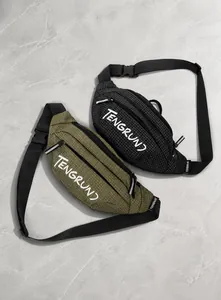 Detail of grid texture and brand logo on black and olive crossbody waist bags