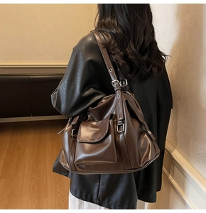 Detail of vintage large dark brown shoulder bag with silver buckle and smooth leather finish