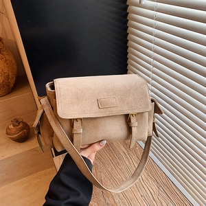 Minimalist tan faux suede crossbody bag with decorative buckle and wide strap for women