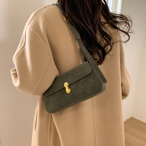 Detail of vintage dark green underarm bag with gold metal buckle and matte finish