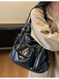 Retro black oversized tote bag with multi-pocket design and silver metal eyelets straps