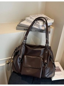Retro large brown leather tote bag with silver metal eyelets and front flap pocket